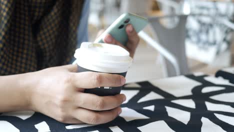 women hand holding smart phone and paper coffee cup ,