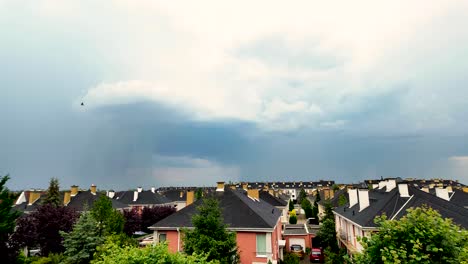 rainstorm over a suburban neighborhood with dark clouds looming in the sky, timelapse