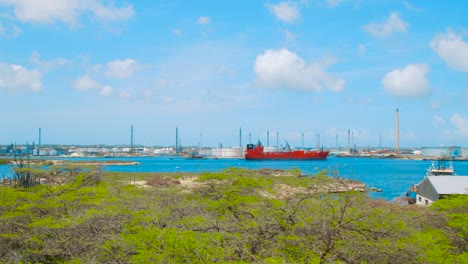 pan of red oil tanker laying in harbor of oil refinery isla, curacao