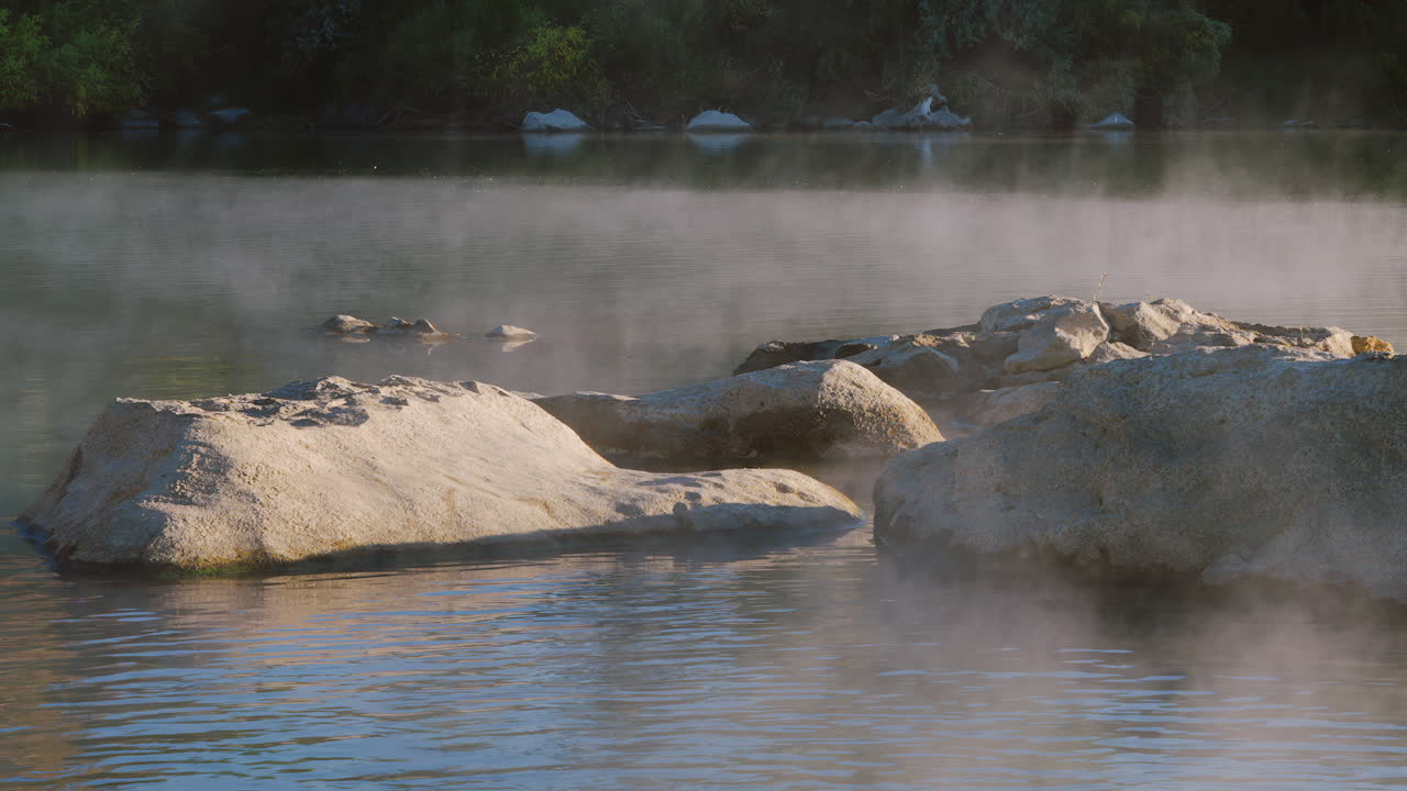 Calm Nature Of A Foggy River With Boulders. Slow Motion, Pan Left Shot