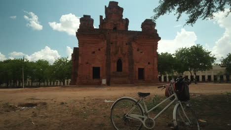 A-bike-is-parked-infront-of-a-Temple-in-Bagan,-Myanmar-at-midday-with-no-people