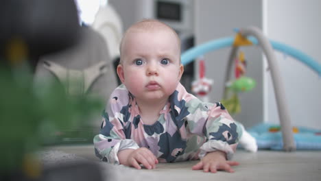 baby crawls on floor toward camera, slow motion