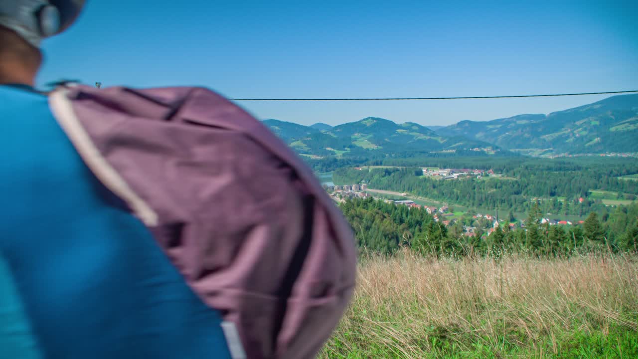Cyclist couple stops to admire panorama in Vuzenica viewpoint