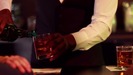 smiling friends toasting whisky glass