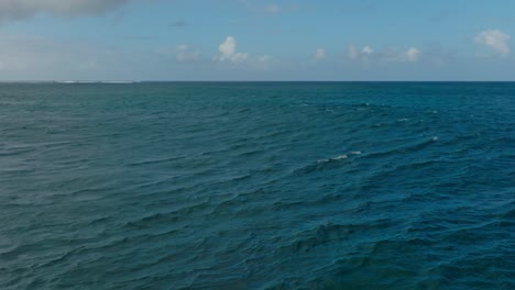 slow motion drone shot of a wave forming at a reef in mauritius