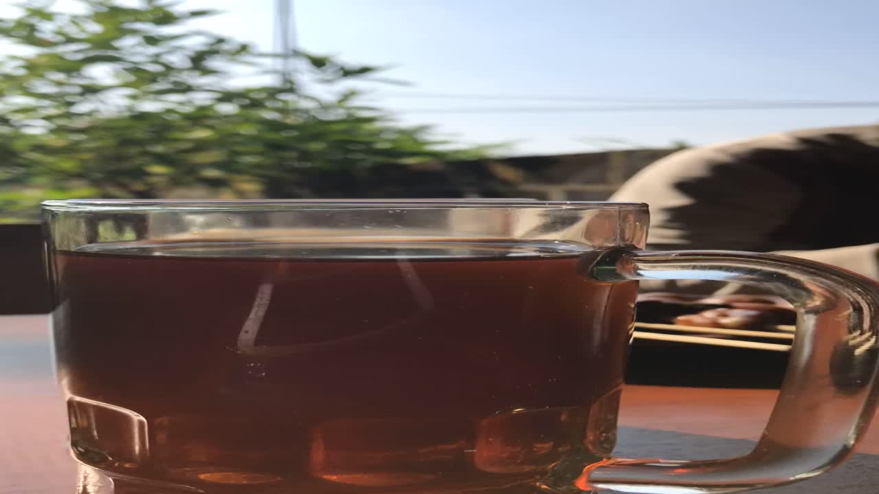 Timelapse of a glass of hot tea on a table with a blurred background in a restaurant