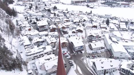 aerial view of austrian village covered in snow, drone shot of oberlängenfeld at winter.  oberlängenfeld covered in snow.