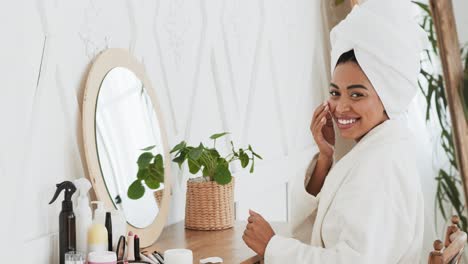 woman applying skincare routine in bathroom