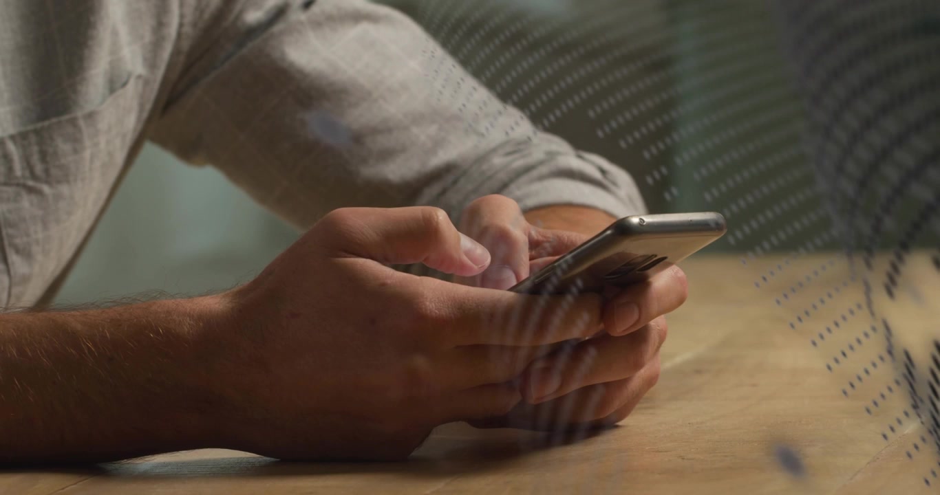 Person Using Smartphone with Digital Data Overlay