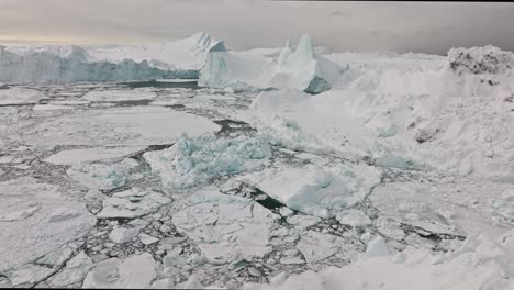 drone over sea and ice of ilulissat icefjord