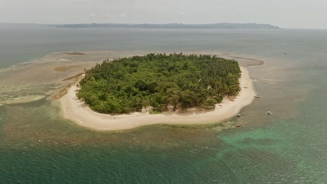 Alingkakajaw-Island,-a-tropical-paradise-boasts-a-white-sand-beach-in-the-Philippines,-nestled-off-the-coast-of-Claver,-a-part-of-Surigao-Del-Norte,-and-is-embraced-by-pristine-waters