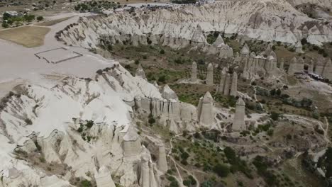 Aerial-view,-Flying-over-Love-Valley-and-its-Fairy-Chimneys,-tourist-attraction-in-Cappadocia,-Turkey