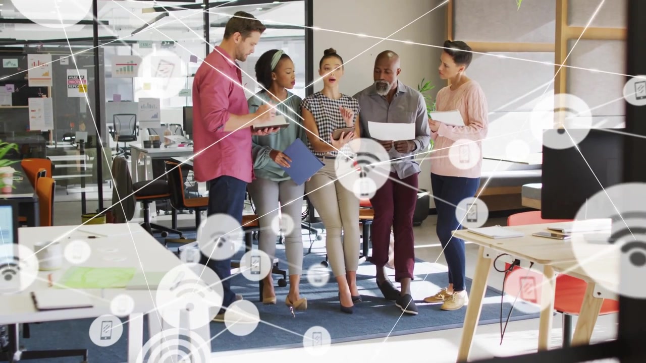 Five coworkers reviewing materials in tech, teen showing phone activating network overlay for work