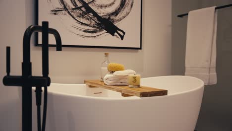 panning shot of a standalone bath tub with bathroom decorations in a luxury home