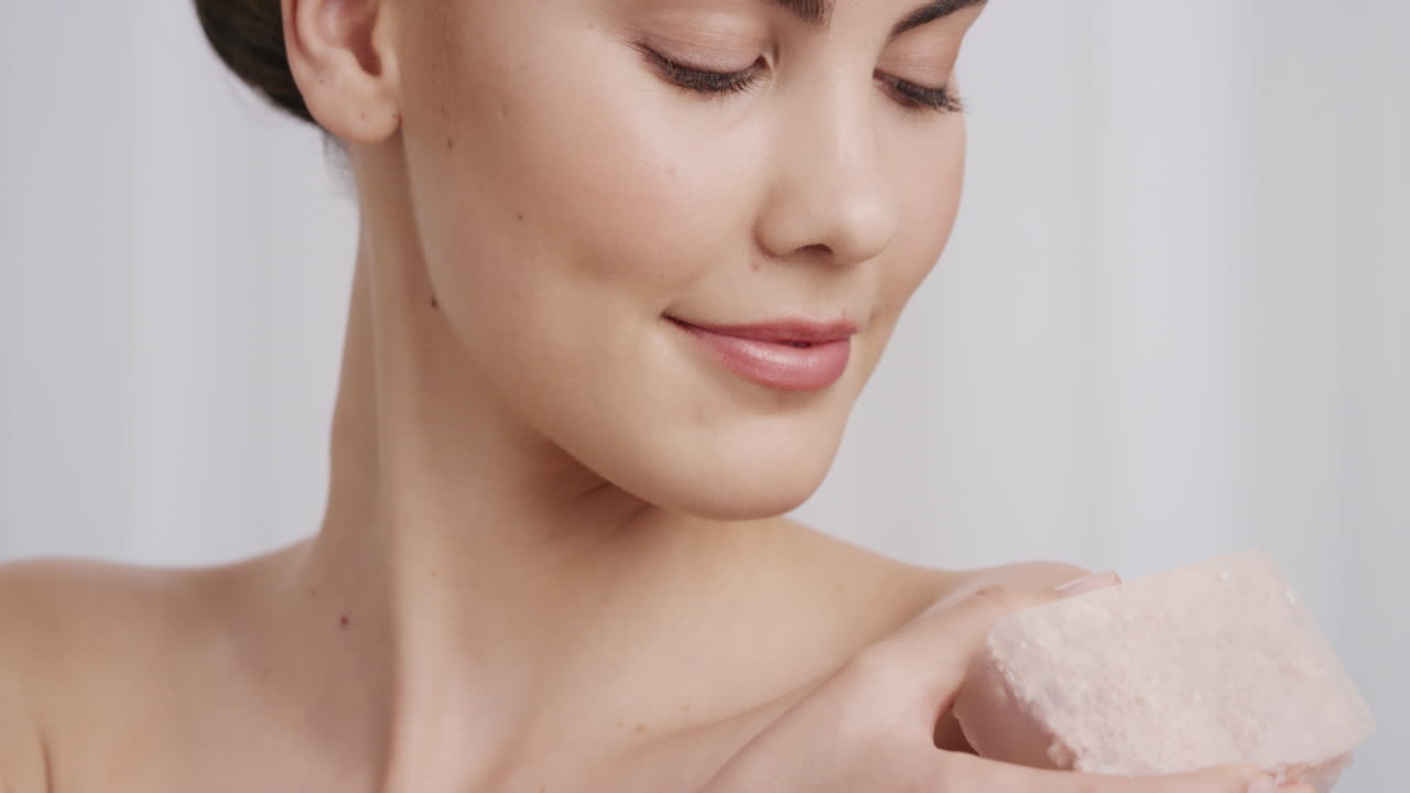 close up portrait gorgeous young woman gently touching nude skin with luxury skincare soap caressing soft complexion beautiful caucasian female enjoying sensual exfoliation