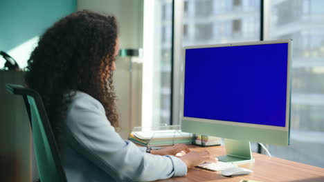 Closeup-unknown-manager-typing-mockup-device.-Professional-watching-blue-screen