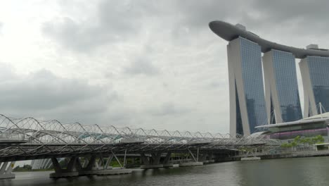 helix bridge marina bay artscience museum singapore panning shot cloudy day