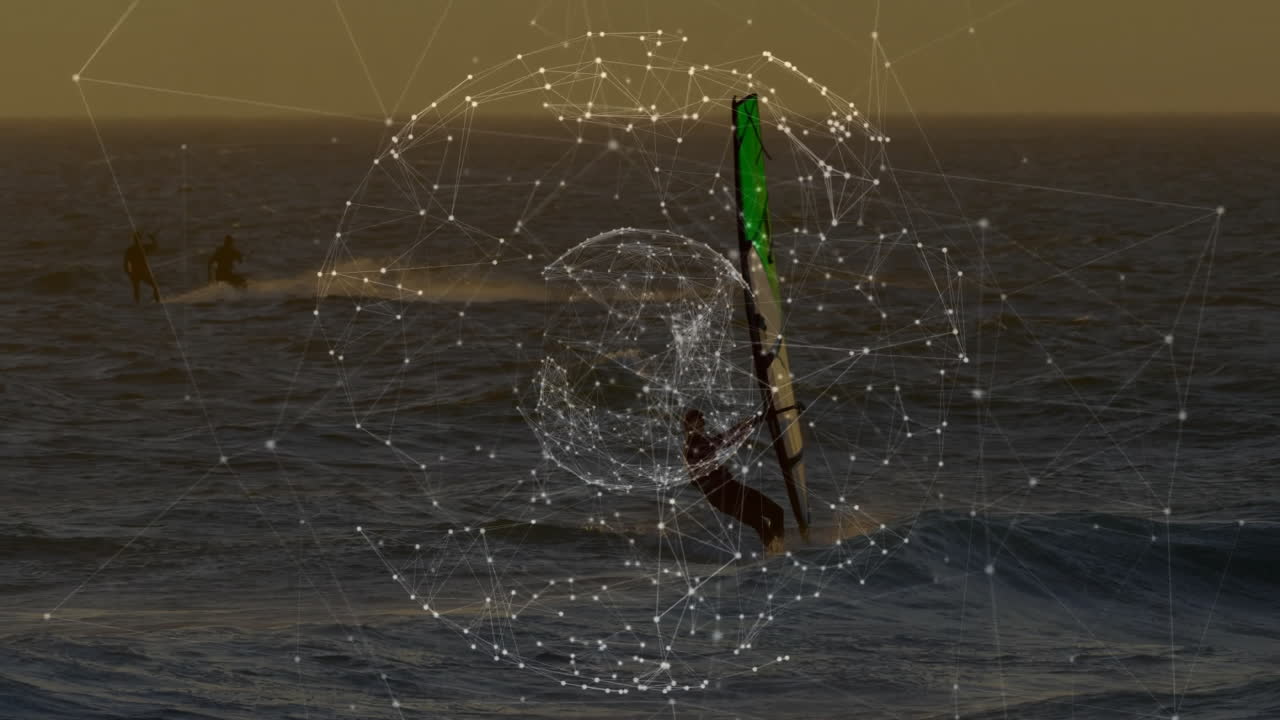 Male windsurfer steering green sail in sunset ocean, with technology network overlay