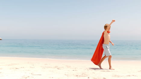 little boy dressed as superman with towel