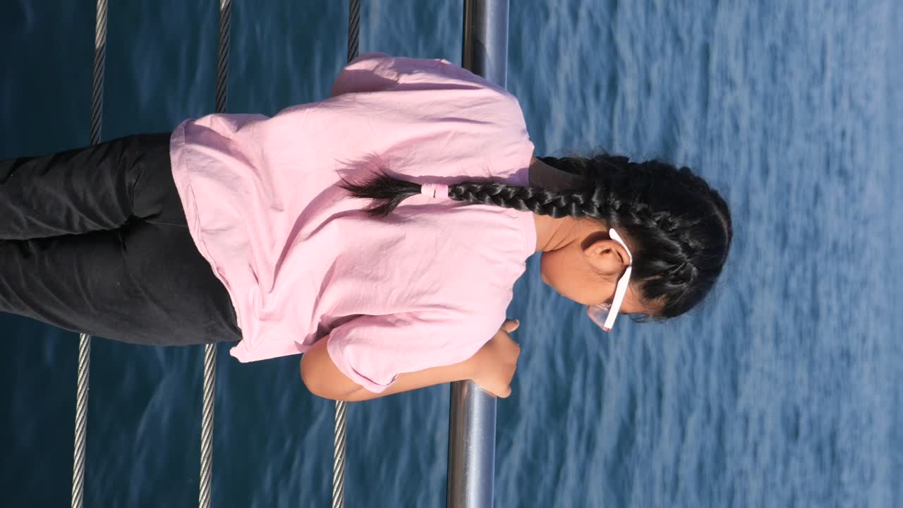 Girl looking at the ocean from a boat