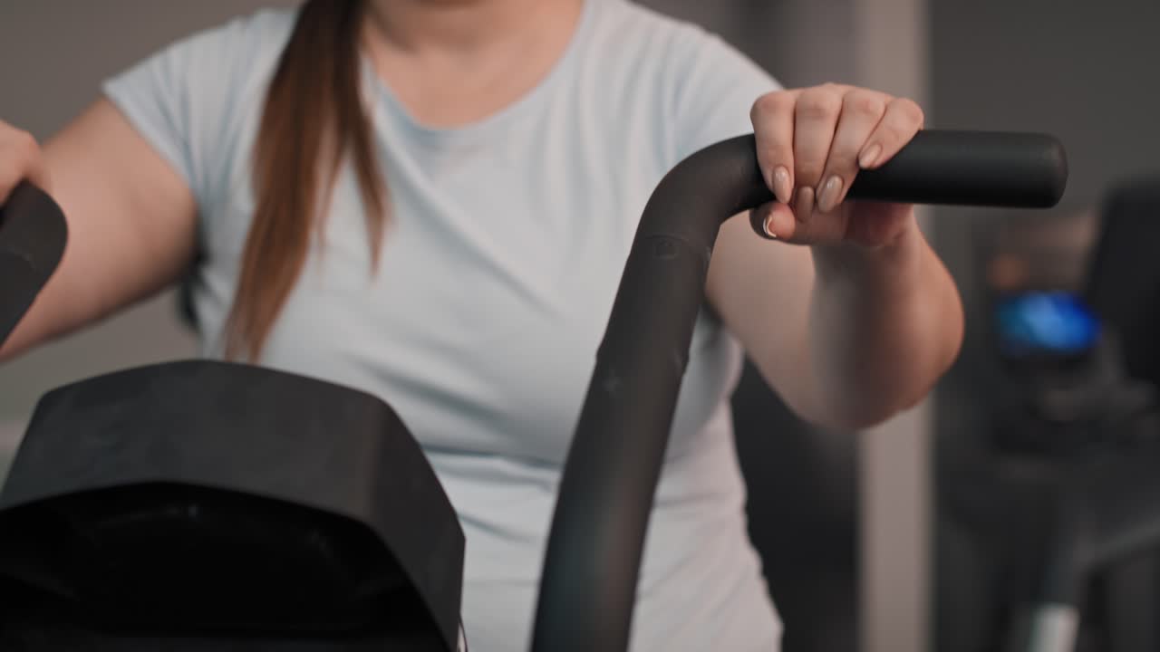 Close up of overweight woman doing training at the gym.