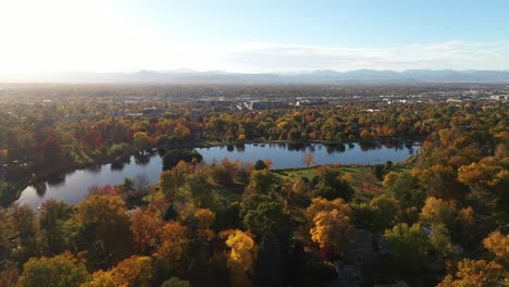 aerial panoramic view of lake in urban nature park in fall season during beautiful sunny morning, denver colorado suburb region