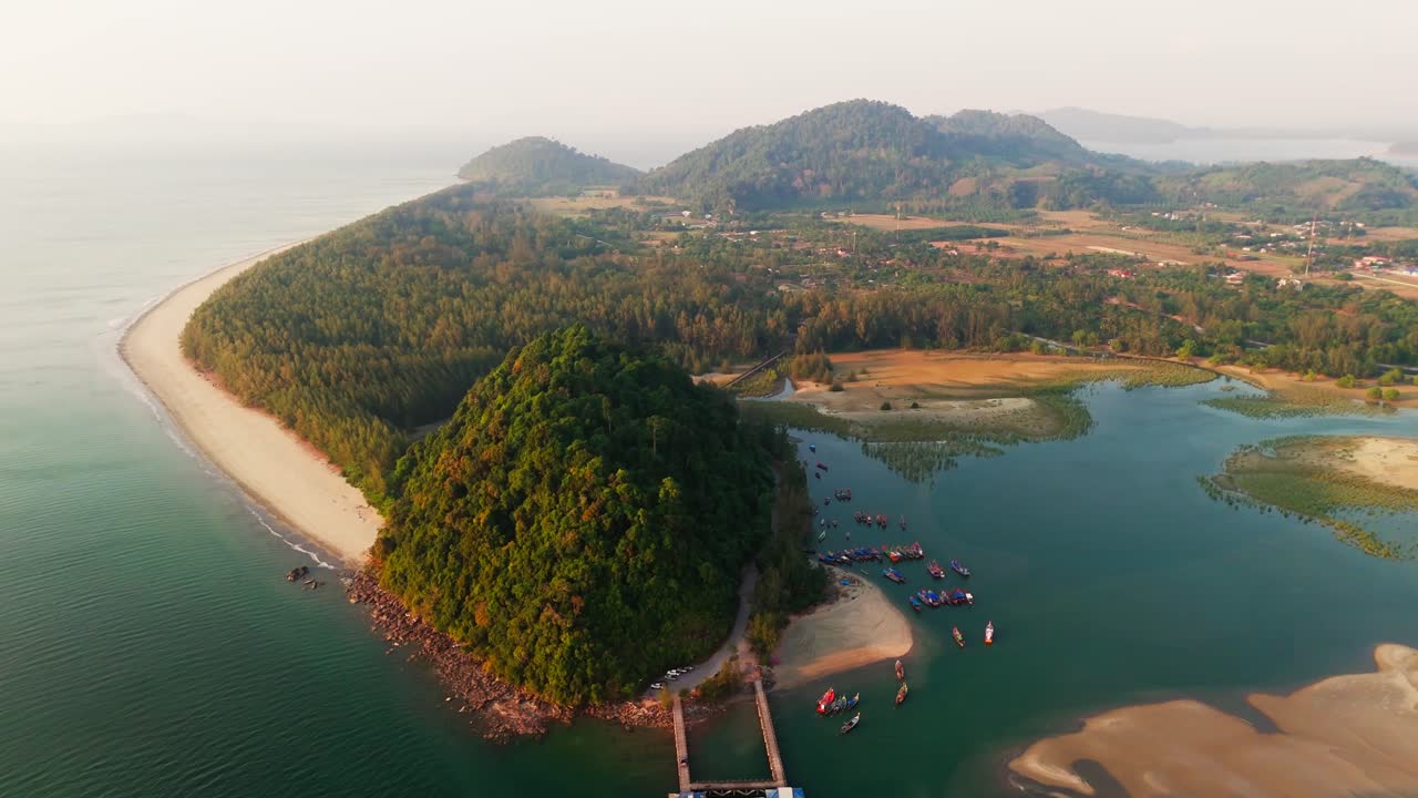 Aerial drone pullback from peninsula with boats in Laem Son National Park, Thailand, coastal landscapes, beaches, and forests