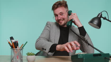 happy business man talking on wired vintage telephone of 90s advertising phone call communicating