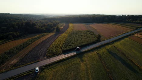 aerial view of tractor driving back home farm