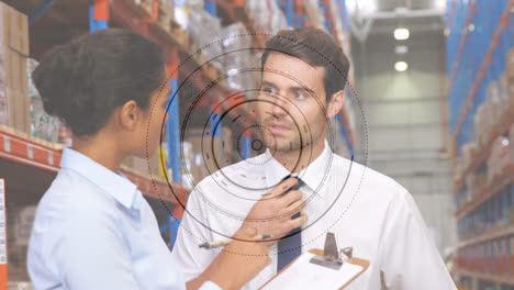 Animation-of-scope-scanning-over-man-and-woman-working-in-warehouse