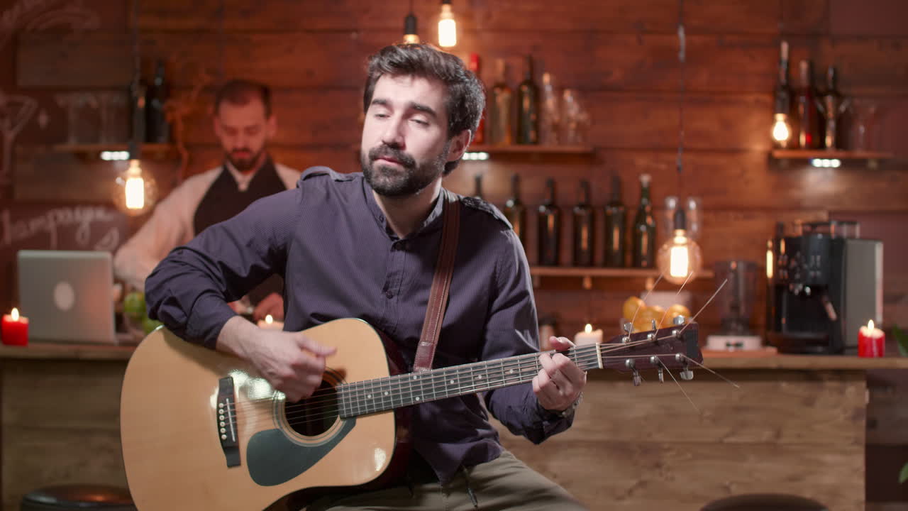 Man playing guitar at a bar