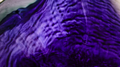 abstract fluid art: swirling purple and green acrylic pour painting