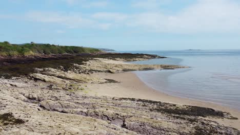 traeth lligwy anglesey island eroded coastal shoreline aerial view flying across weathered coastline