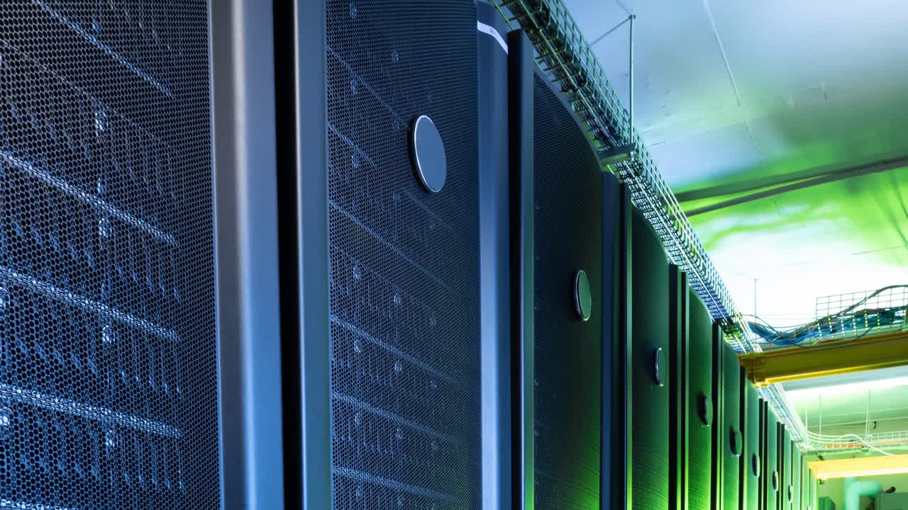 Video of empty corridor with row of green and blue computer servers