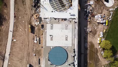 Construction-site-of-massive-new-and-modern-building-in-Kaunas,-aerial-top-down-view