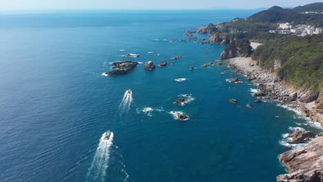 small-boats-cruising-along-beautiful-coastline