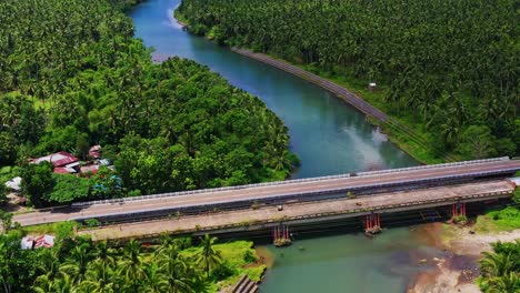 road bridge over the lawigan river surrounded with lush green forest in saint bernard, southern leyte, philippines