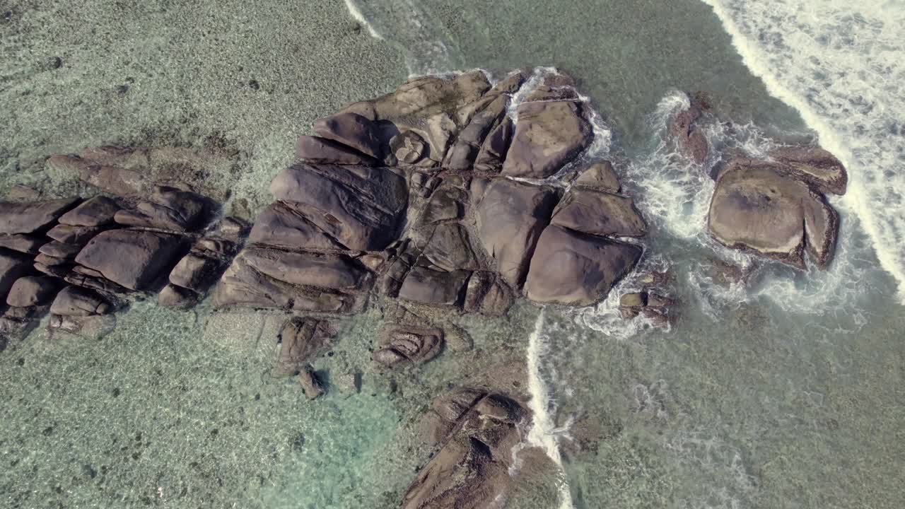 Drone footage passing over rocks in ocean, Anse forbans, Mahe Seychelles 30fps 005