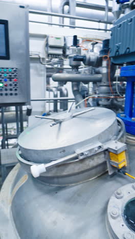 equipment at dairy plant. modern complex industrial equipment for milk production. vertical video