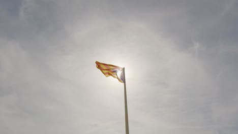 catalan flag flying in the sky of sant feliu de guises on the costa brava of catalonia