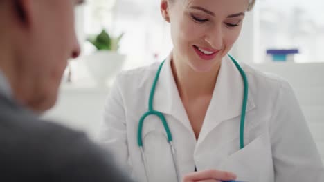 Handheld-view-of-doctor-showing-examination-results-on-the-clipboard