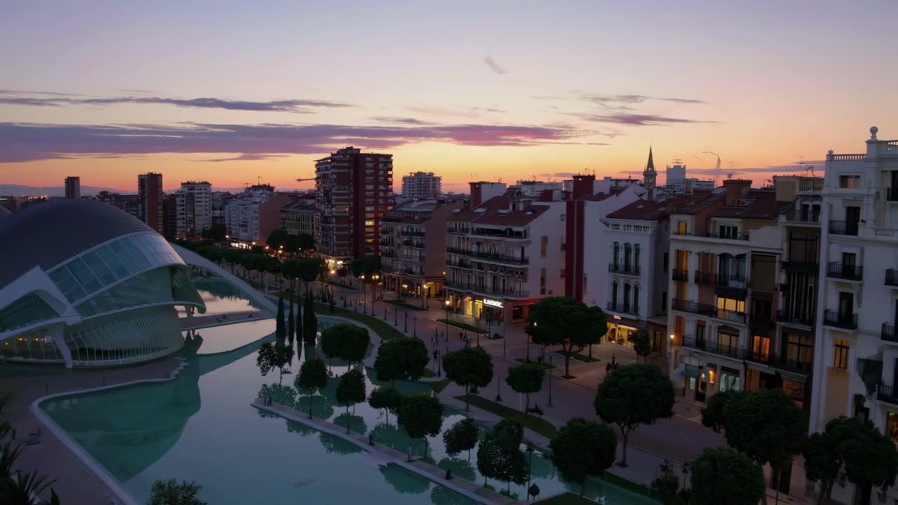 Vista aérea de un paisaje urbano al atardecer, donde se muestra la arquitectura moderna e histórica