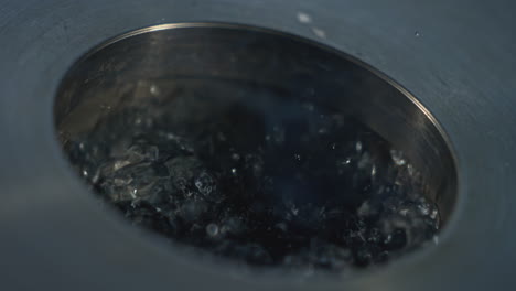 water draining into a metal sink