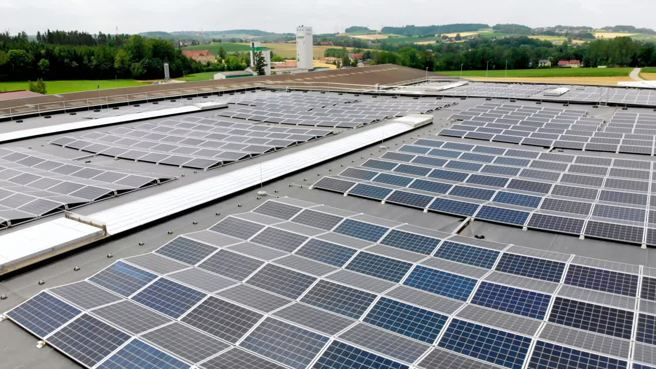 Wide shot of factory rooftop with solar panels.