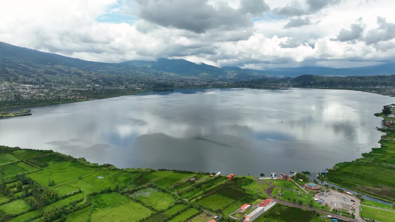 Picturesque drone shot of overcast day over reflective lagoon and mountain range. Naturescape.