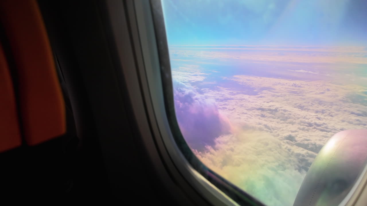 Aircraft engine and cloudy horizon from a high-altitude plane, capturing the expanse of the sky