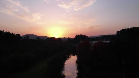 Fly-Above-River-at-Beautiful-Sunset