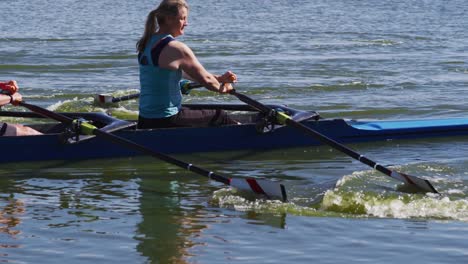 senior caucasian man and woman rowing boat on a river