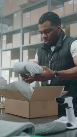 warehouse worker packing boxes