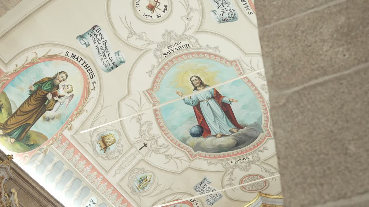 Ceiling fresco of Jesus and saints with ornate details inside historic church